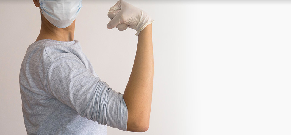 A masked person flexes their bicep | Wake Clinical Research