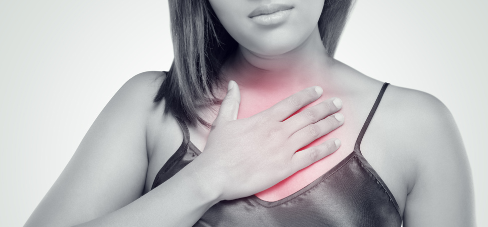 pictured: a person places her hand above her heart, which glows red to indicate pain