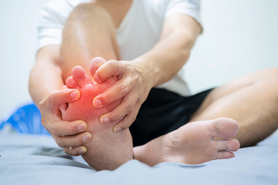 Man holding inflamed foot